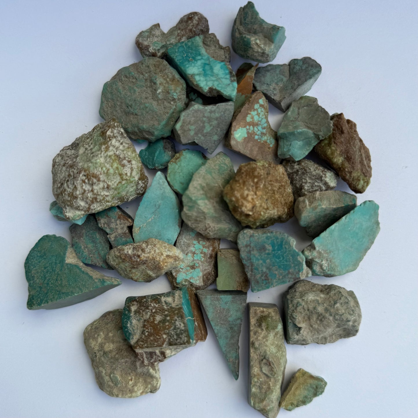 Pile of turquoise fragments on a light background