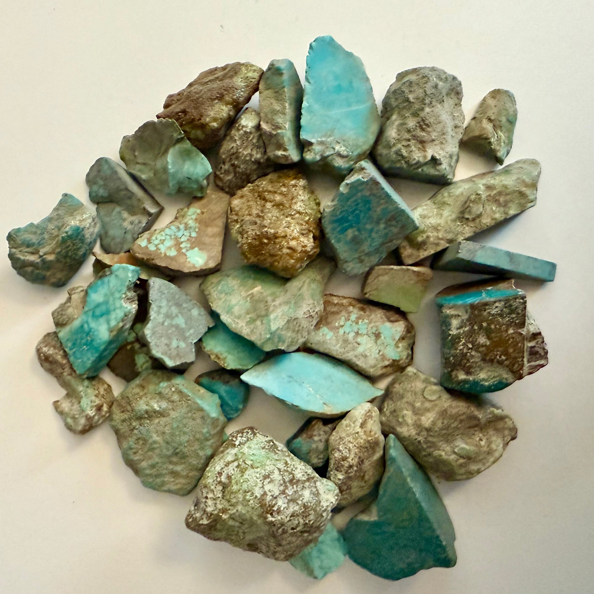 Pile of turquoise fragments on a light background