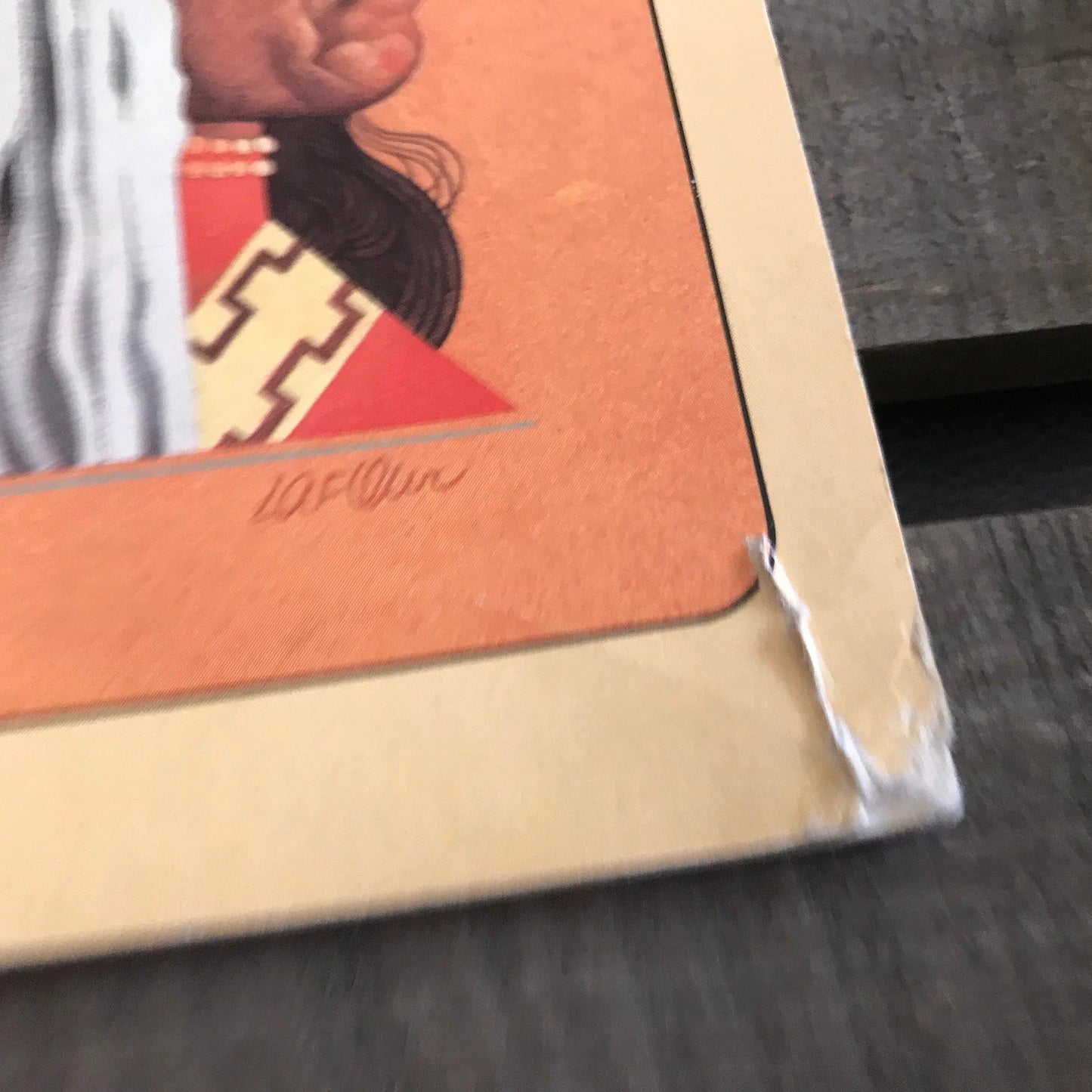 Close-up of a framed artwork on a textured surface