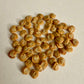 Pile of small, round, beige seeds on a light background
