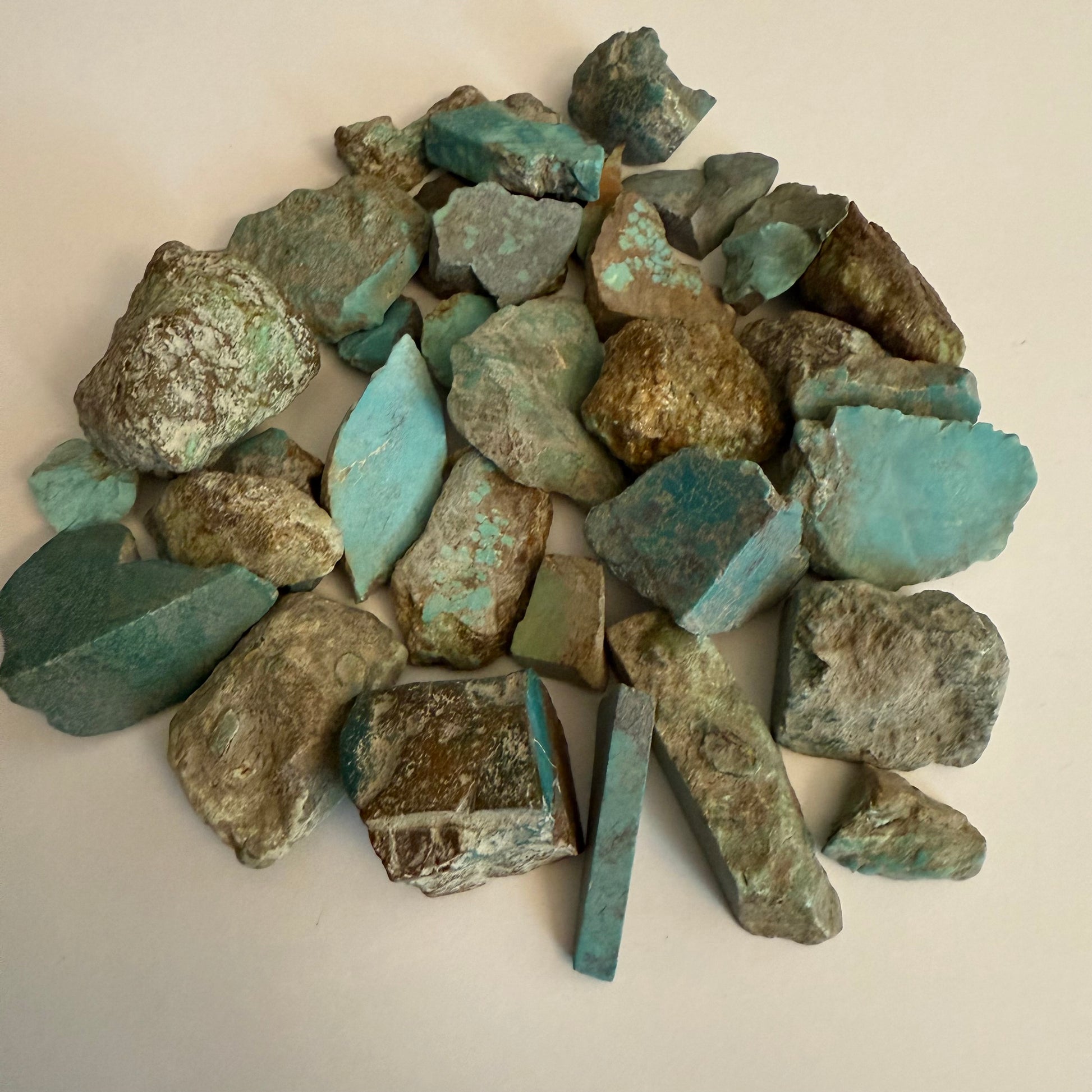 Pile of turquoise fragments on a light background