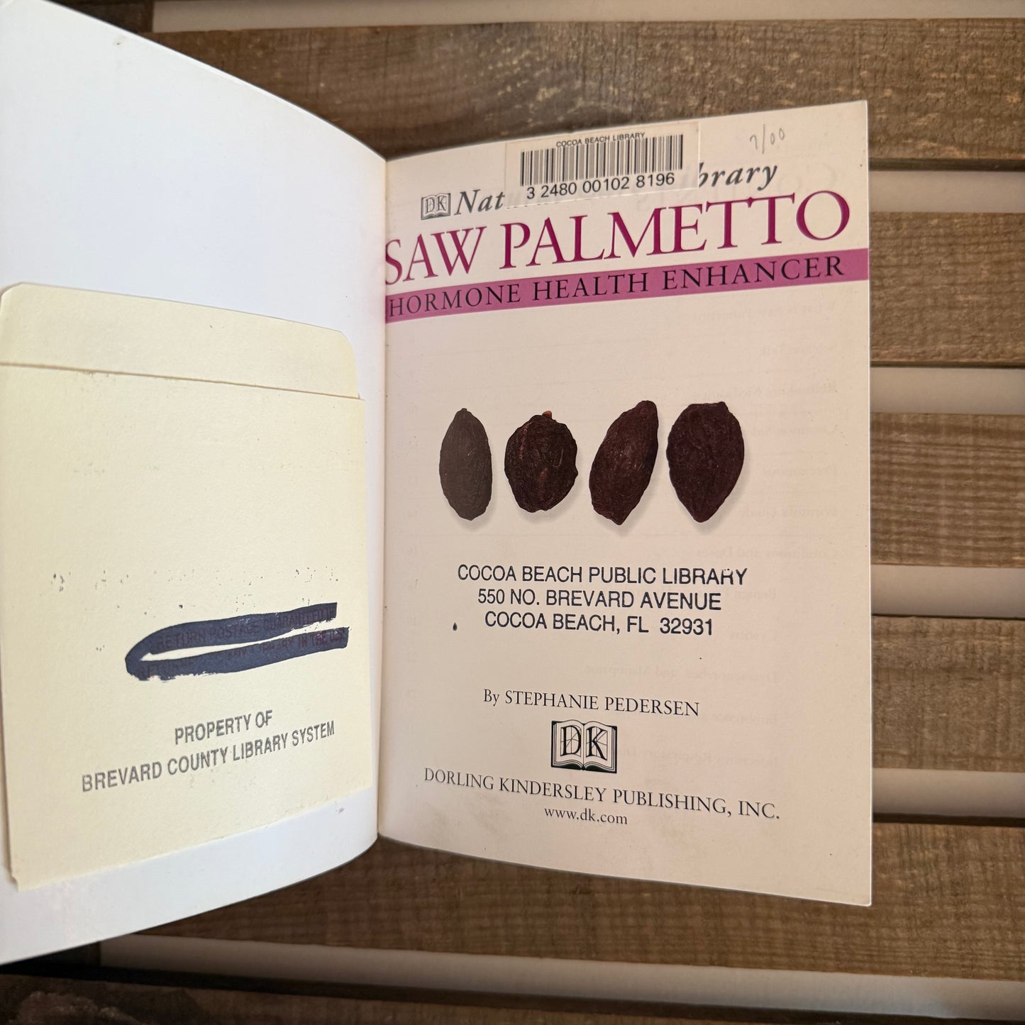 Open book with a page featuring 'Saw Palmetto' and a library label.