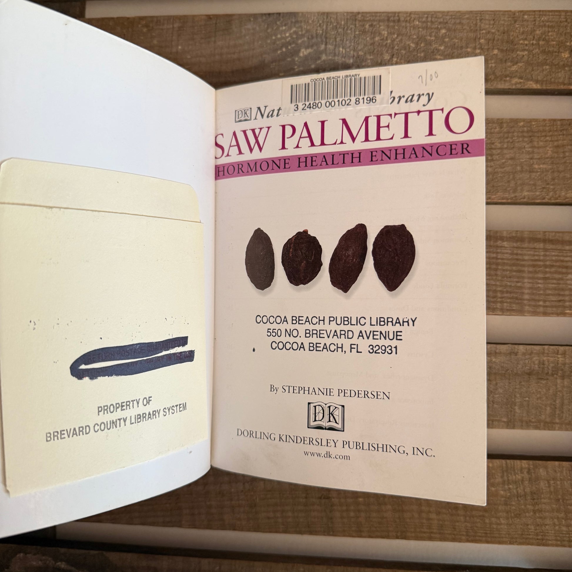 Open book with a page featuring 'Saw Palmetto' and a library label.