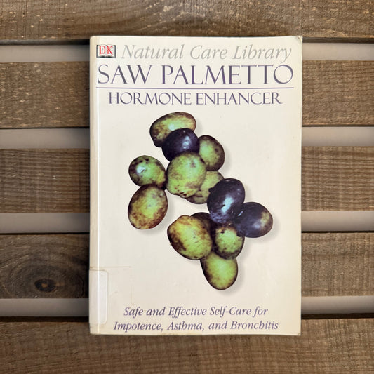 Book titled 'Saw Palmetto Hormone Enhancer' from the Natural Care Library on a wooden background