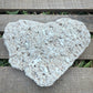 Heart-shaped stone on a wooden surface