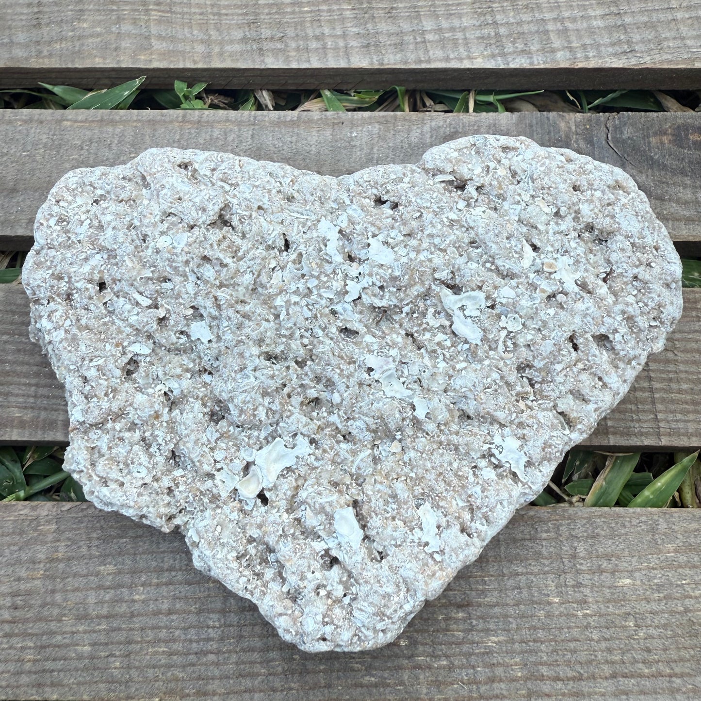 Heart-shaped stone on a wooden surface