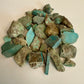 Pile of turquoise fragments on a light background