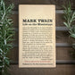 Book titled 'Life on the Mississippi' by Mark Twain on a wooden background with plants.