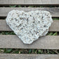 Heart-shaped stone on a wooden surface