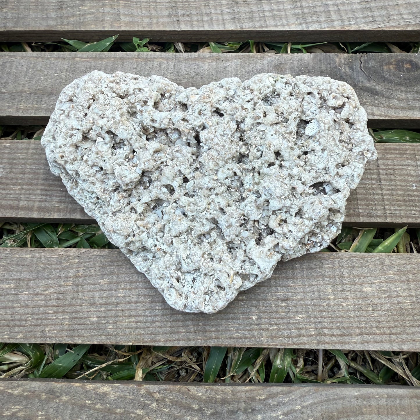 Heart-shaped stone on a wooden surface