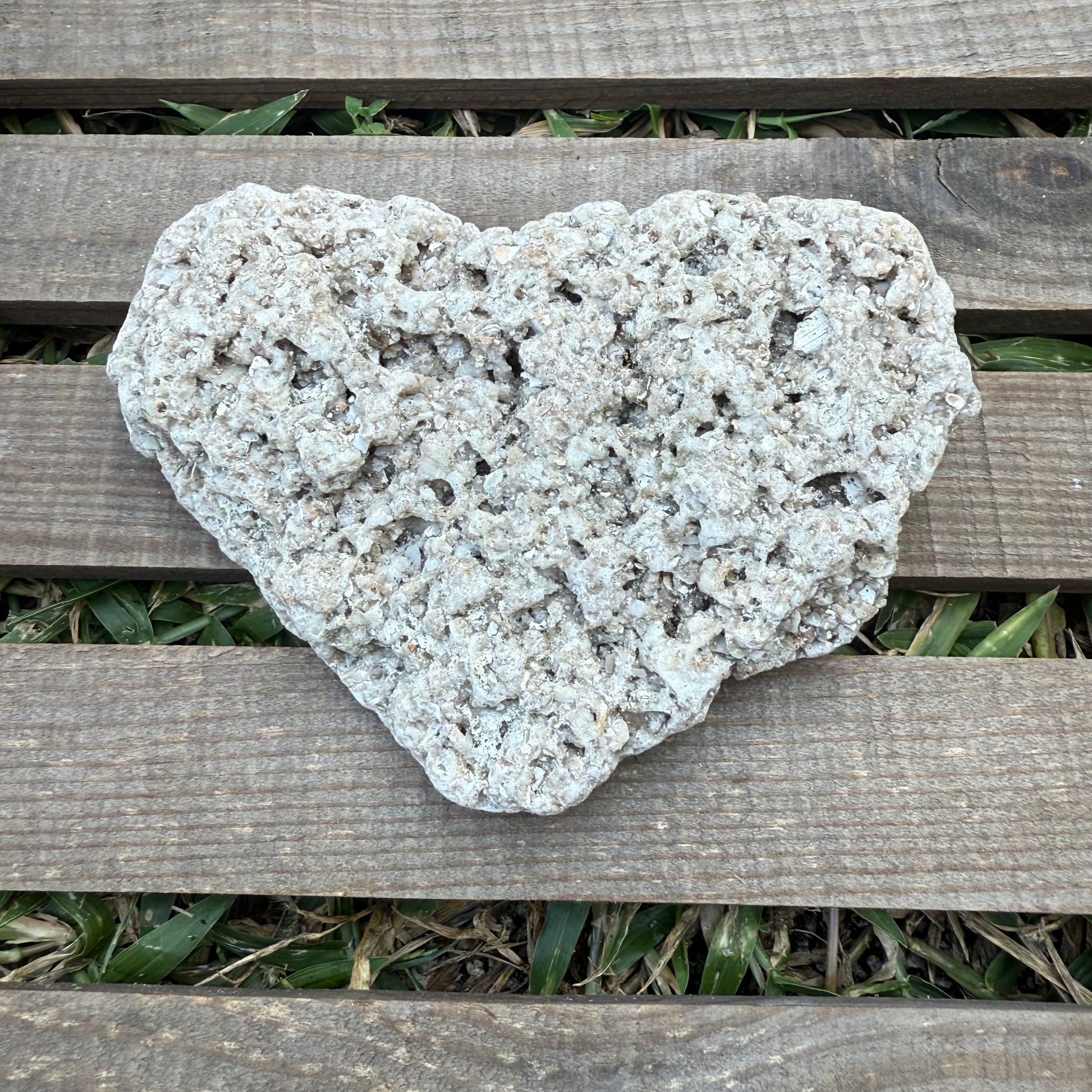 Heart-shaped stone on a wooden surface